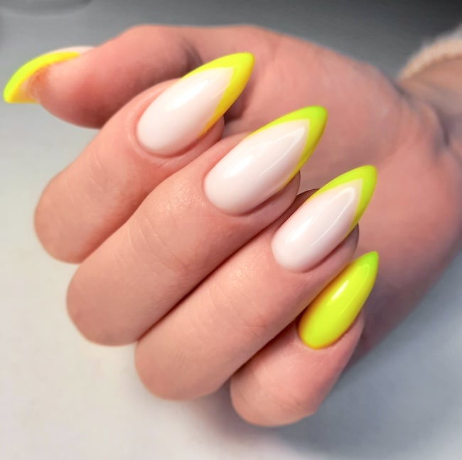 Yellow neon French tip stiletto nails.