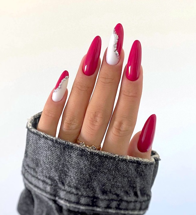 Red and white nails with rhinestone swirl.