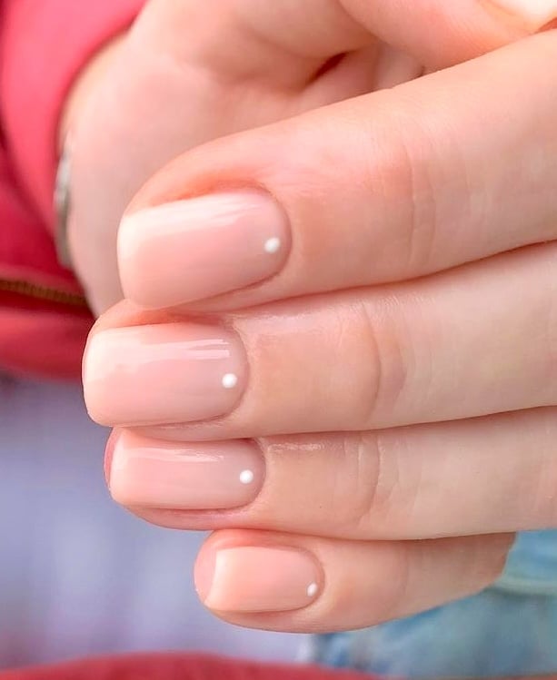 White dot nude nails.