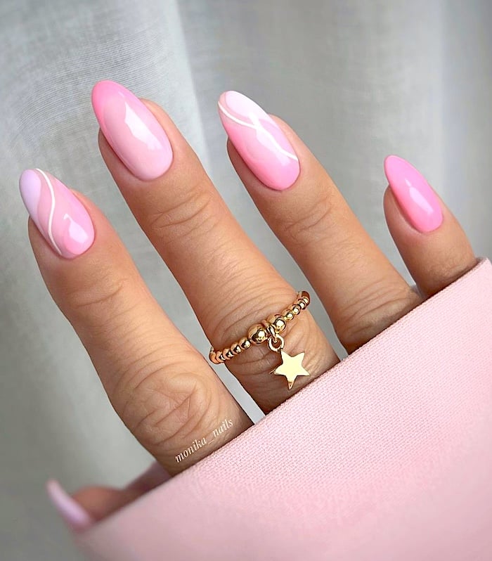 Pink and white swirls nails.