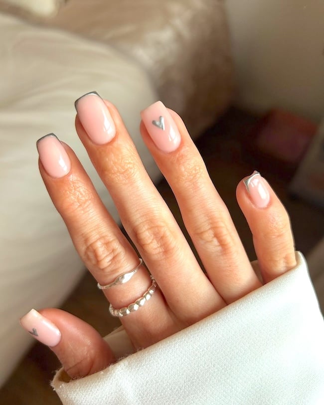 Nude nails with silver heart.