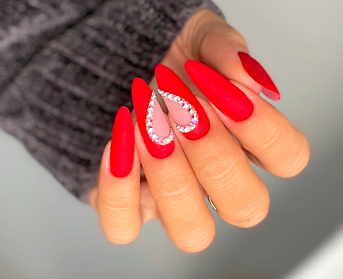 Matte red nails with rhinestone heart.