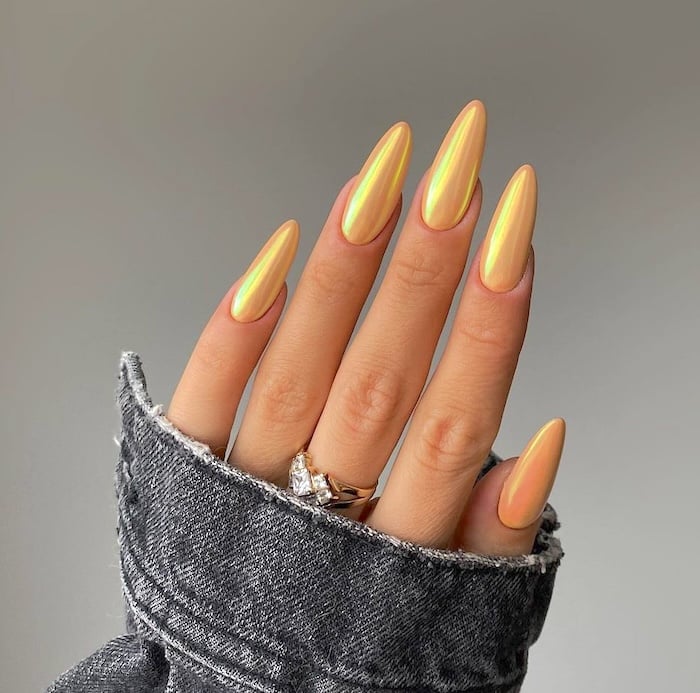 Yellow chrome nails.