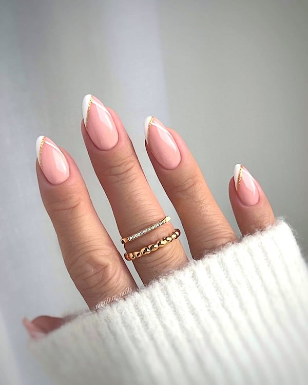 Angled French tip nails with golden accent lines.