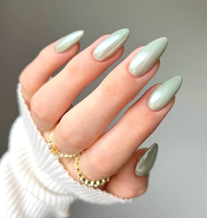 Pale green chrome nails.