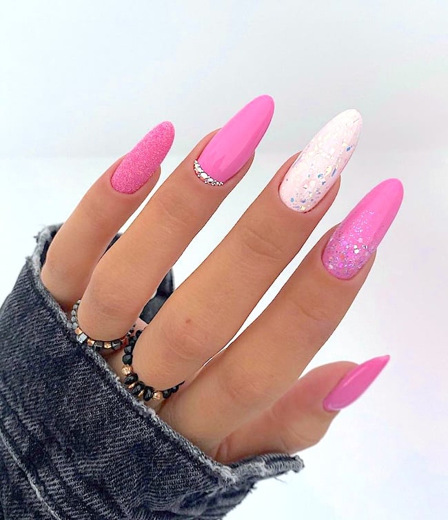 Pink and white glitter nails.