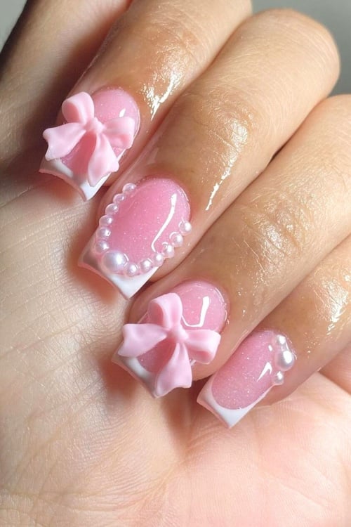 Coquette pink bow nails.