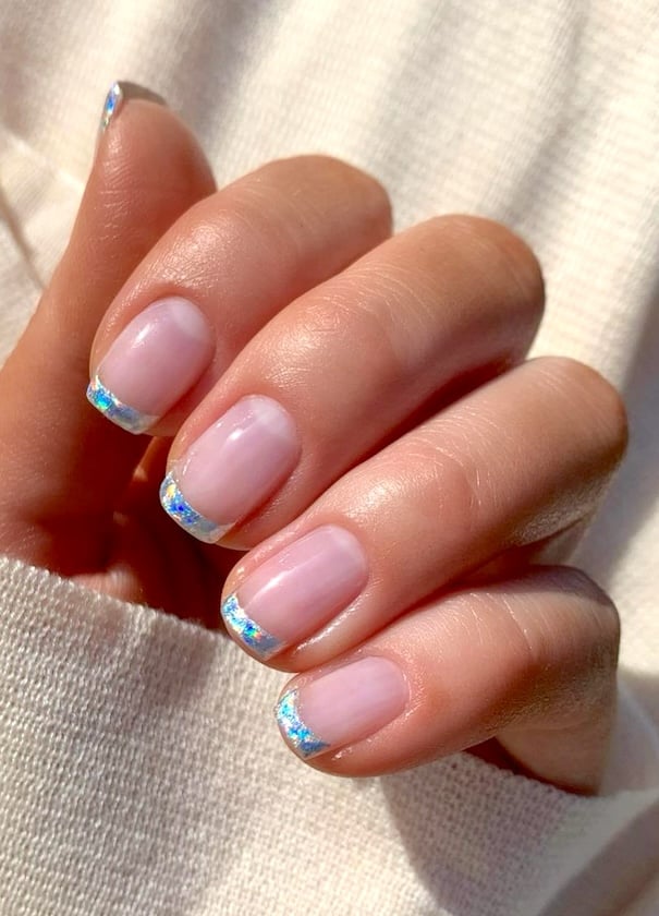 Nude blue French tip nails.