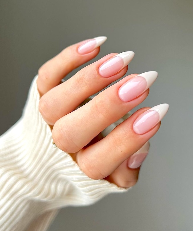 Pink French tip almond nails.