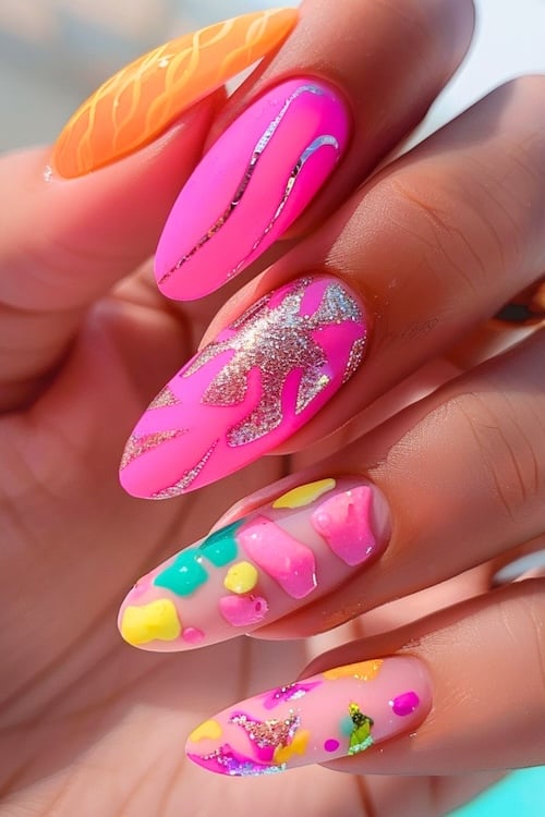 Neon nail art in pink, green, and yellow on bright summer nails.