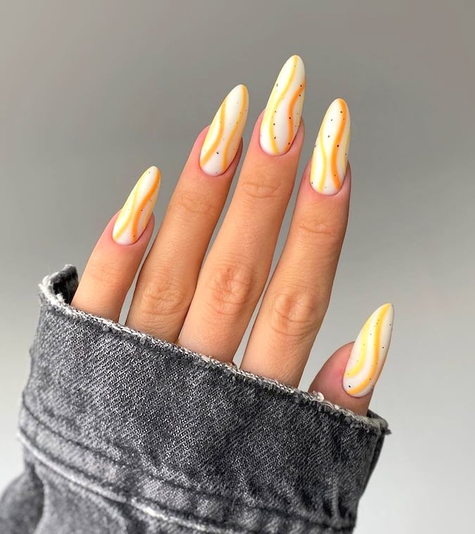 Orange April almond nails.