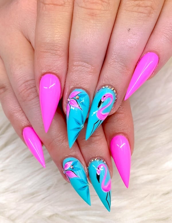 Flamingo pink and blue bright summer stiletto nails.