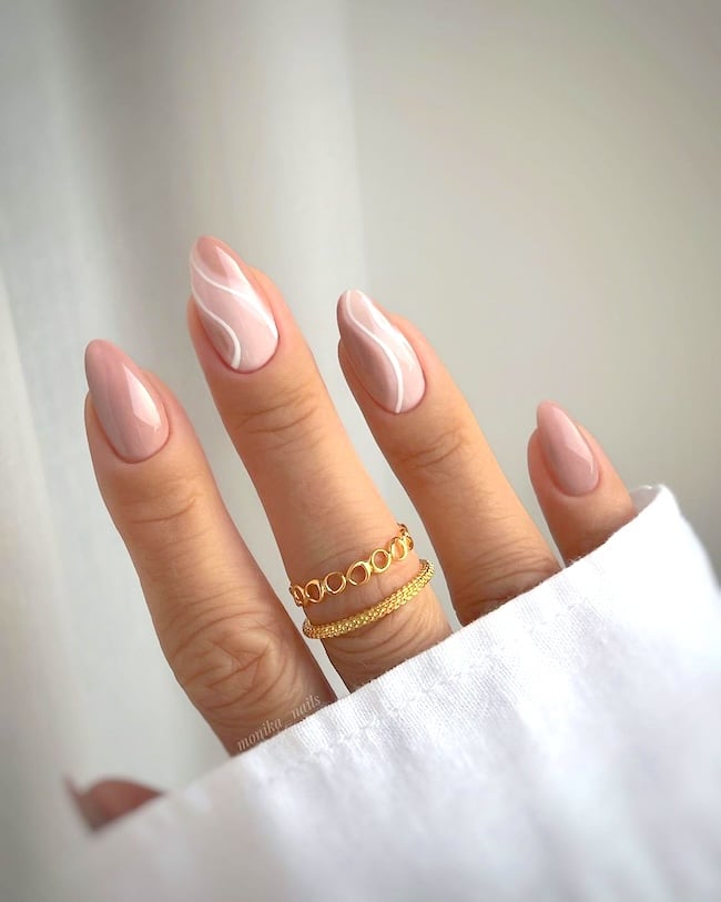 Nude swirl nails.