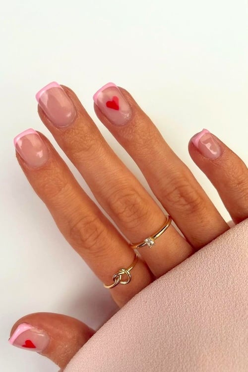 Red heart French tip nails.