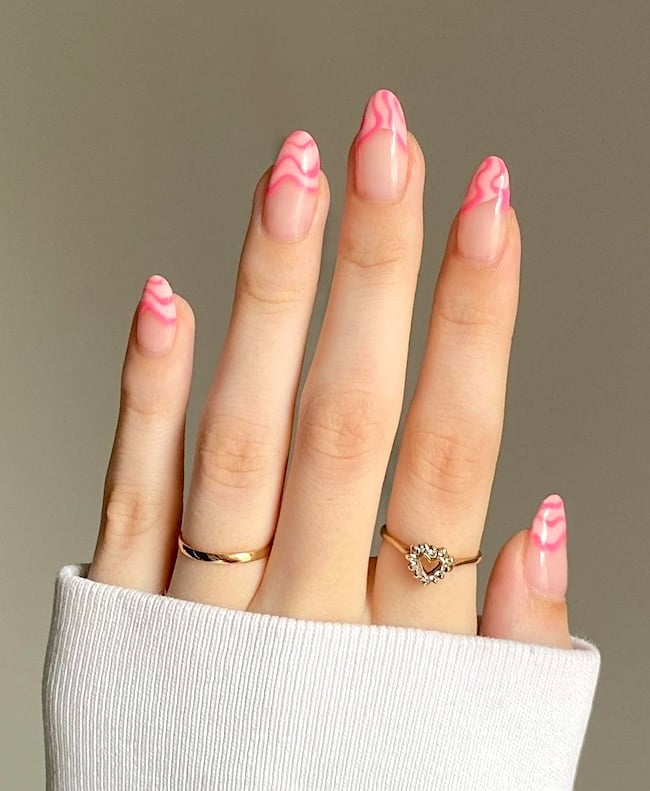 Pink French tip almond nails.