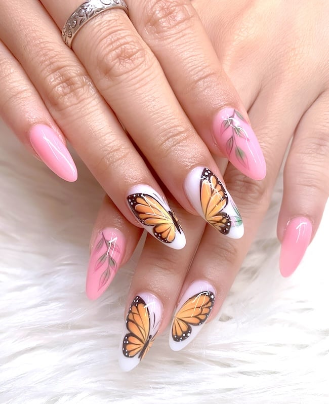 Pink, orange, and white butterfly nails.