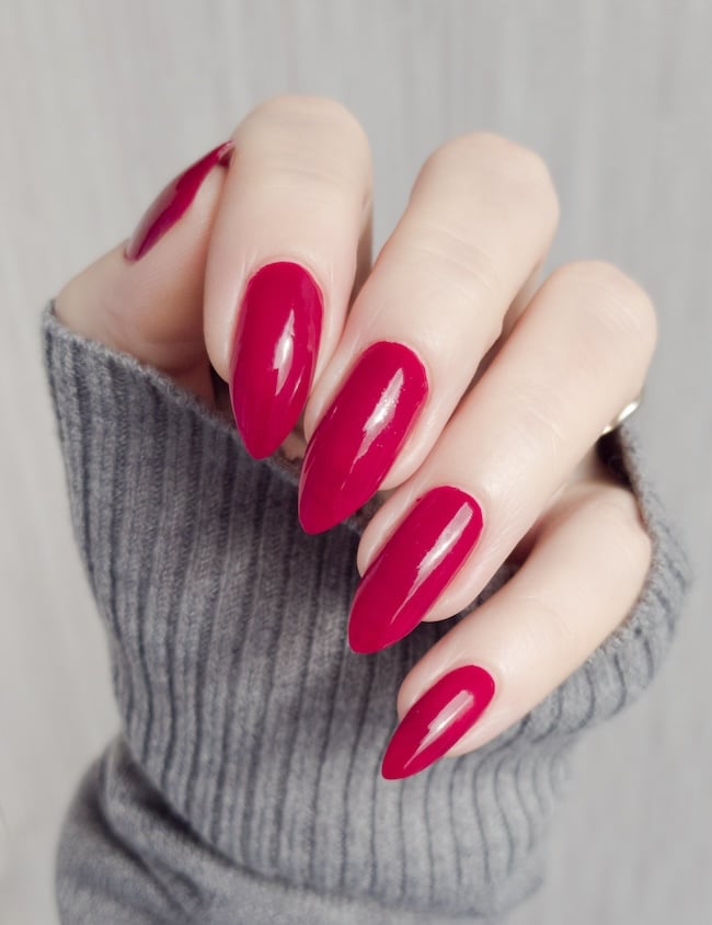 Sharp red almond nails.