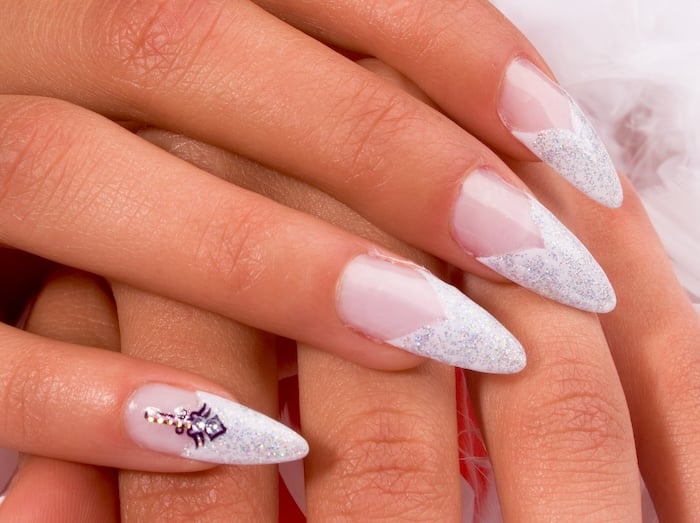 Sparkle stiletto French tip nails.