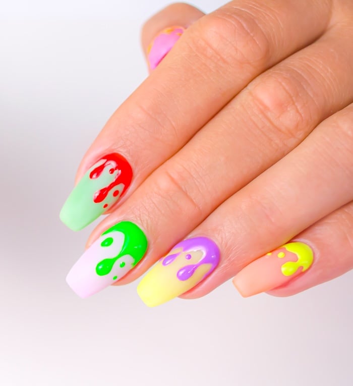 Bright paint splatter square summer nails.