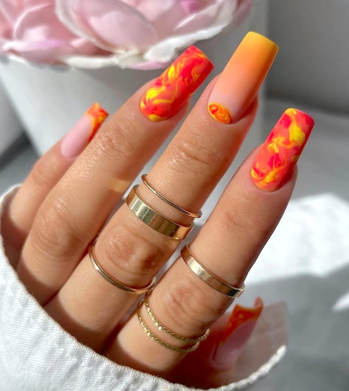 Orange swirl neon nails.