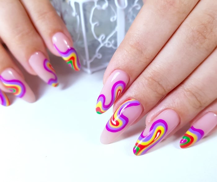 Colorful purple, yellow, red, green, and pink swirl summer nails.