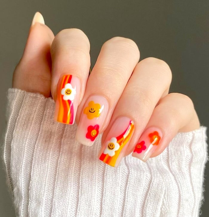 Floral orange neon nails.