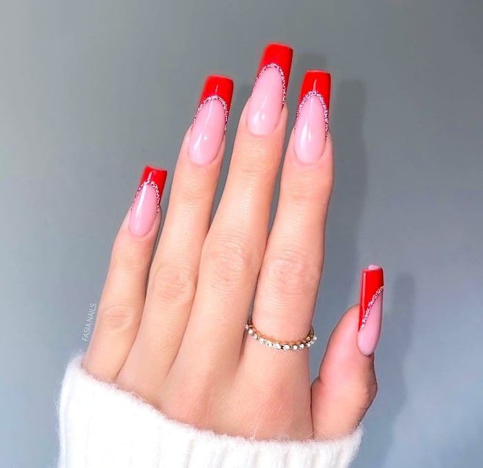 Red glitter French tip nails.