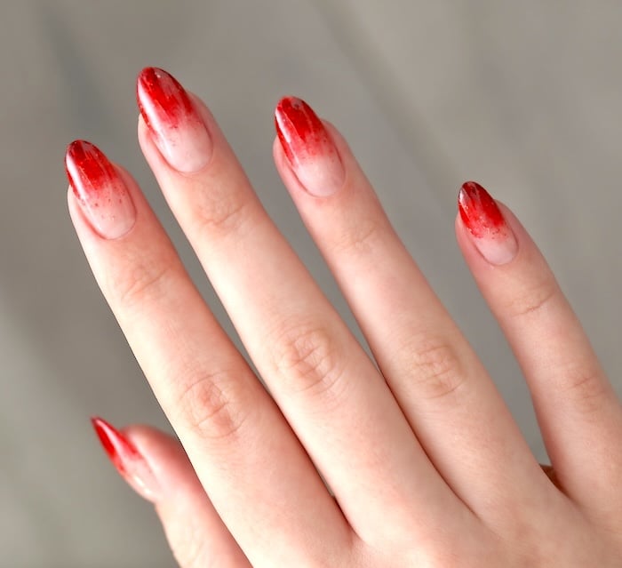 Red ombre French tip nails.