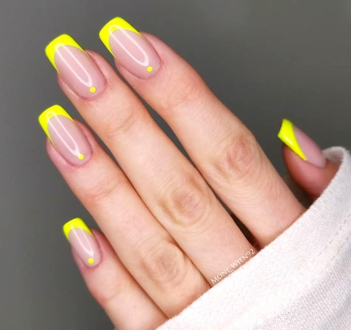 Neon yellow French tip nails.