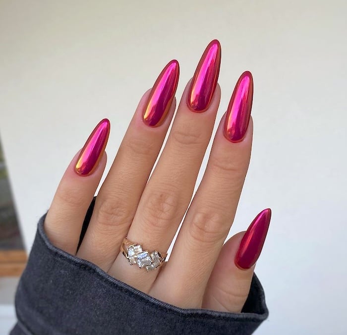 Raspberry chrome almond nails.