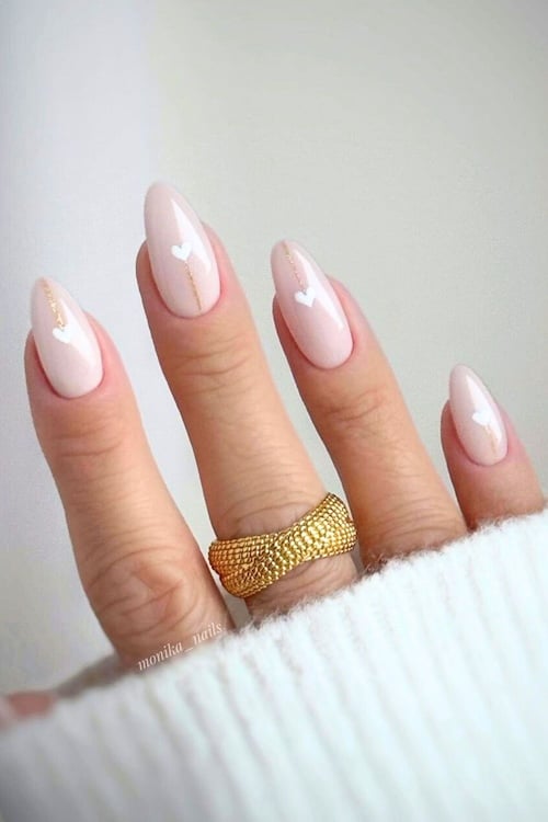 Minimal white heart almond nails.