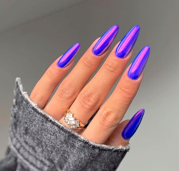 Bright blue purple chrome nails.