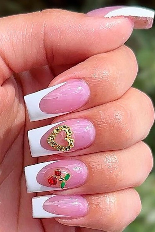 Cherries and hearts French tip manicure.