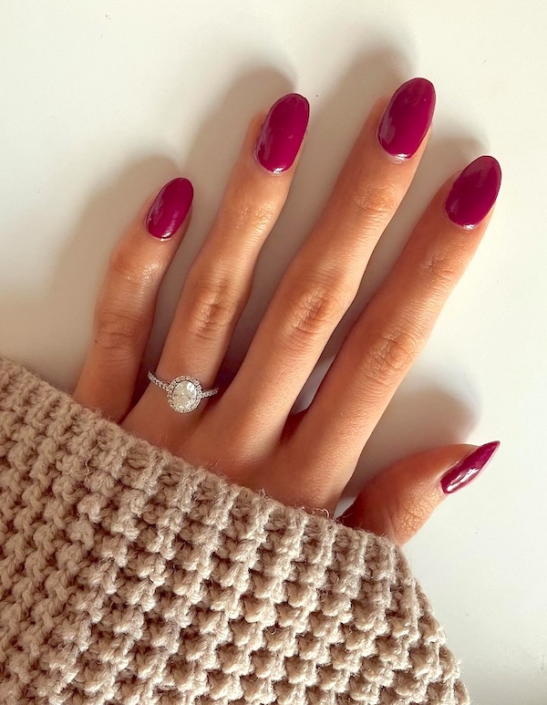 Mid-length red almond nails.