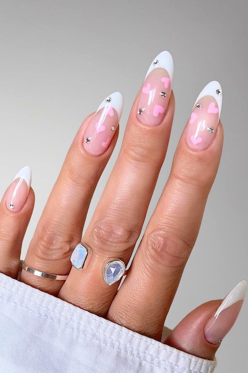 Pink heart French tip manicure.