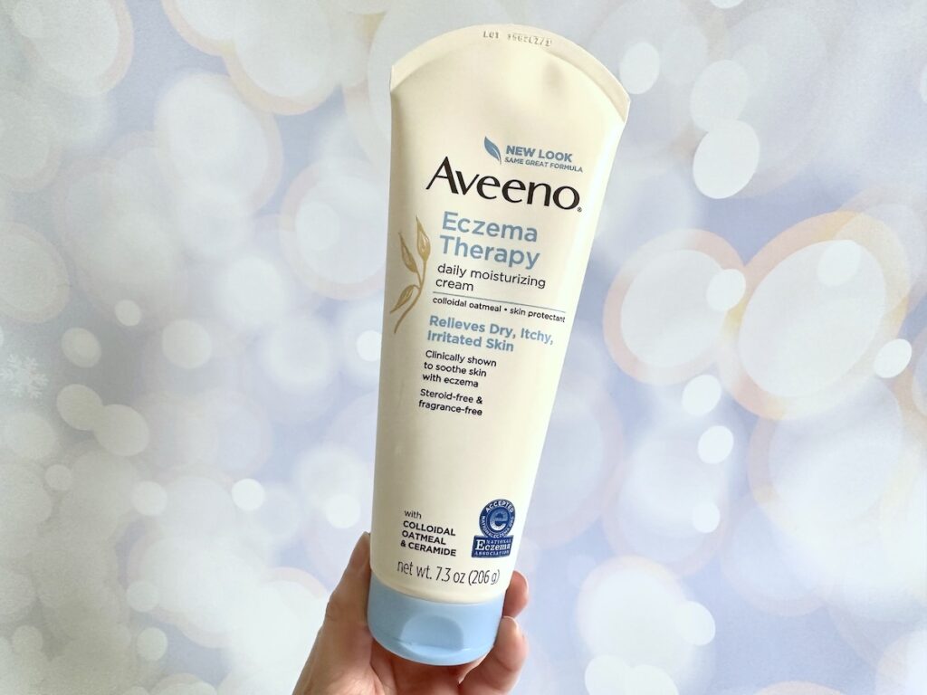 Aveeno Eczema Therapy Daily Moisturizing Cream, handheld.