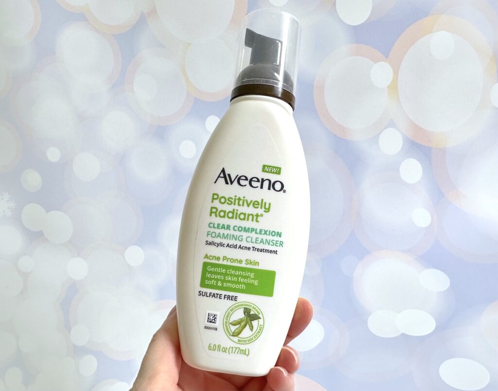 Aveeno Positively Radiant Clear Complexion Foaming Cleanser, handheld.