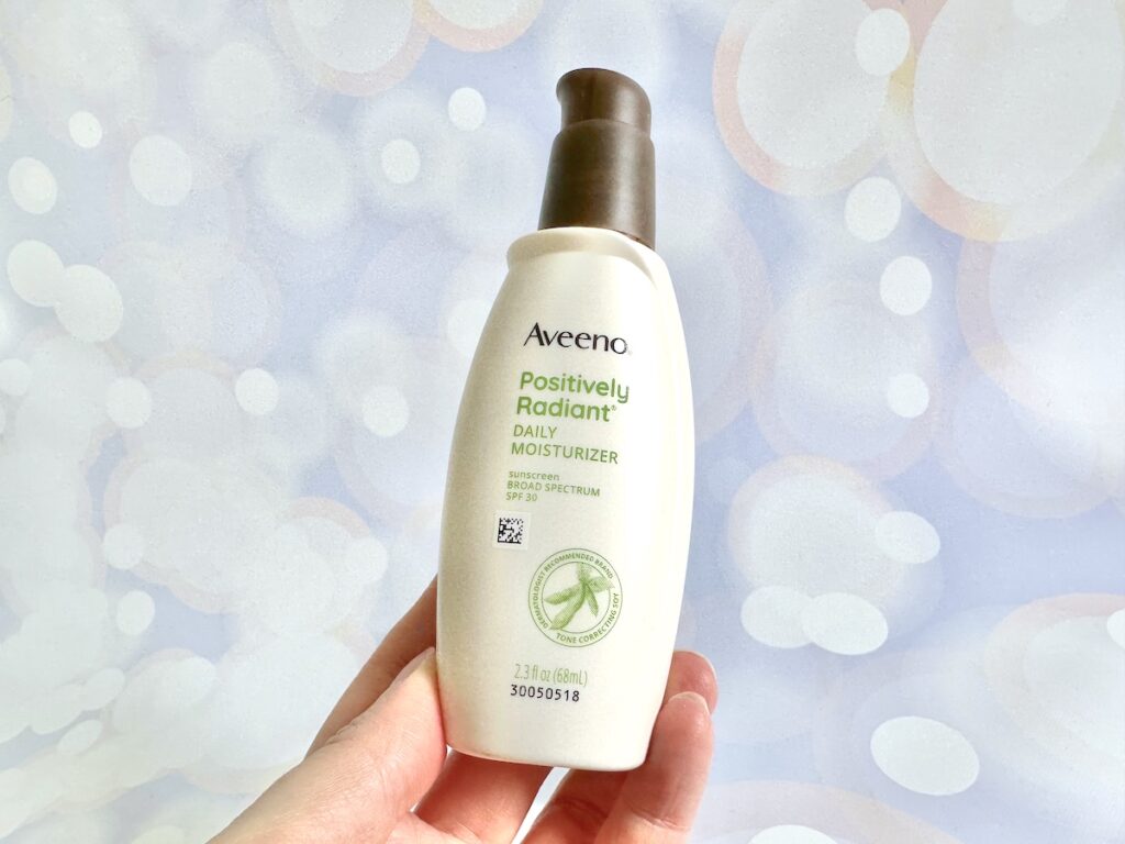 Aveeno Positively Radiant Daily Face Moisturizer Broad Spectrum SPF 30, handheld.