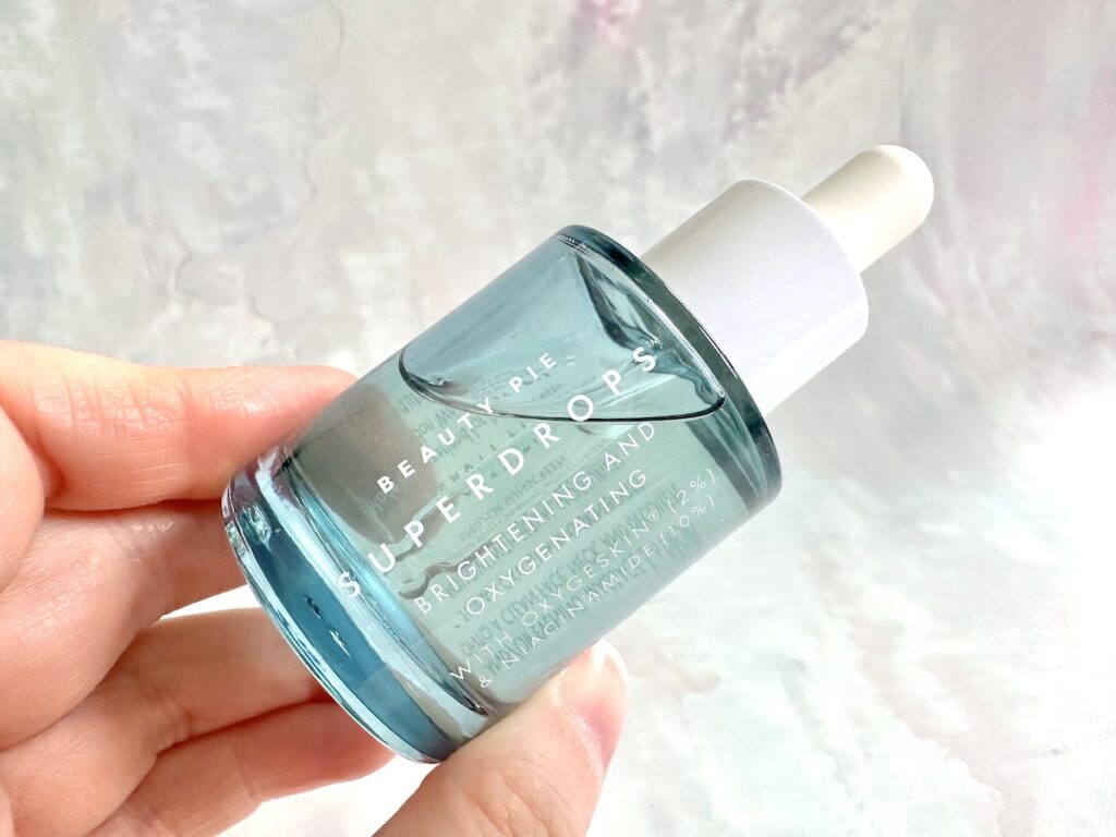 Beauty Pie Superdrops Brightening Niacinamide Serum, handheld.