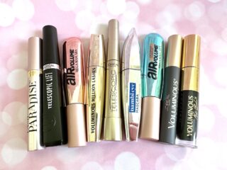 Flatlay of the best L'Oreal mascaras on pink twinkly background.