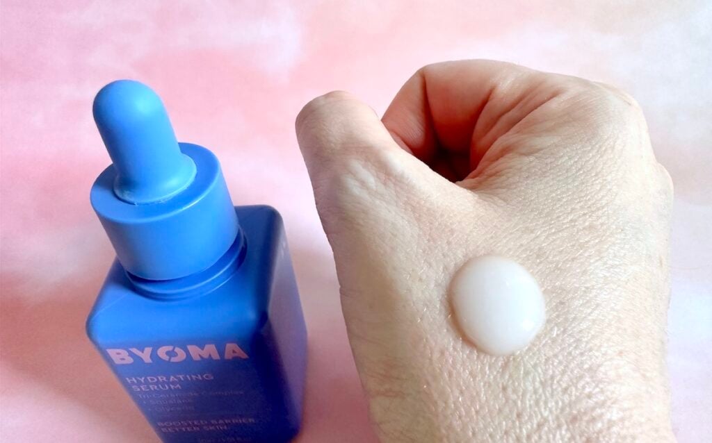 Byoma Hydrating Serum, bottle next to sample on hand.