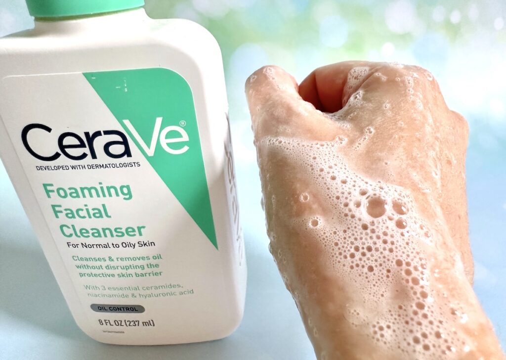 CeraVe Foaming Facial Cleanser bottle next to foam sample on hand.