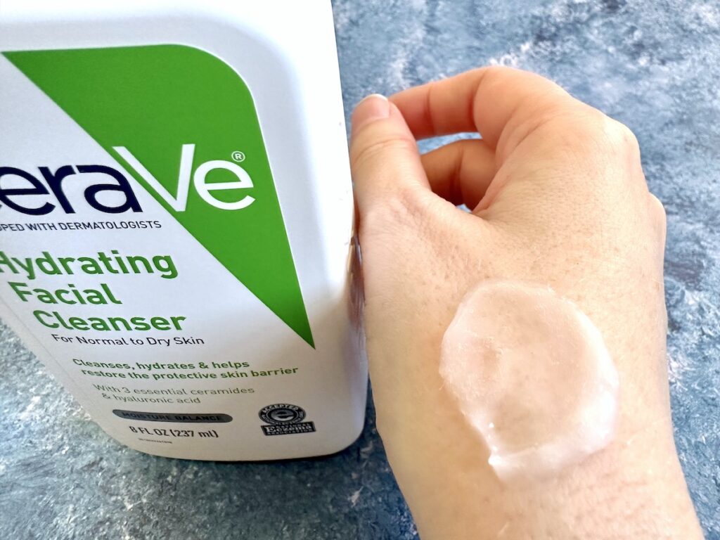 CeraVe Hydrating Cleanser bottle next to sample on hand.