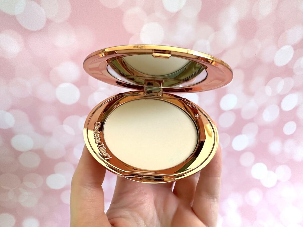 Charlotte Tilbury Airbrush Flawless Finish Setting Powder in the shade Fair, open compact, handheld.