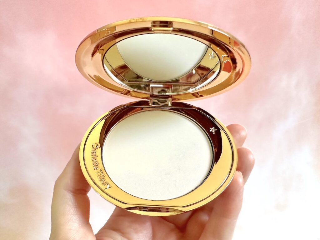 Charlotte Tilbury Airbrush Flawless Finish Setting Powder in the shade Fair, handheld.