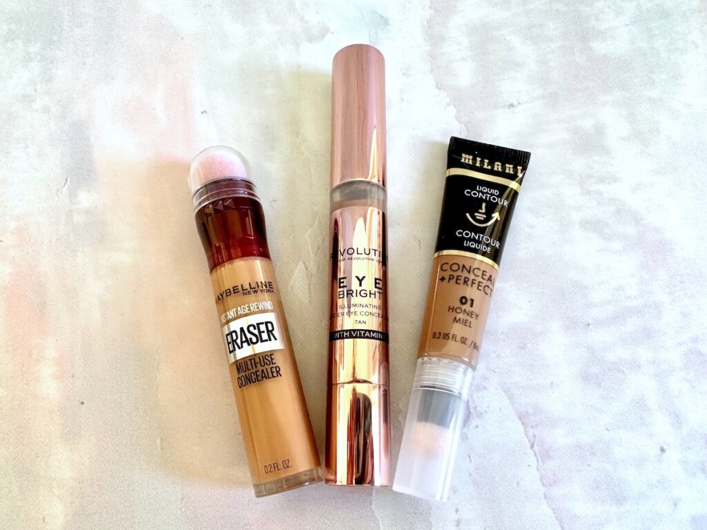 Charlotte Tilbury Contour Wand dupes from Maybelline, Makeup Revolution and Milani, flatlay.