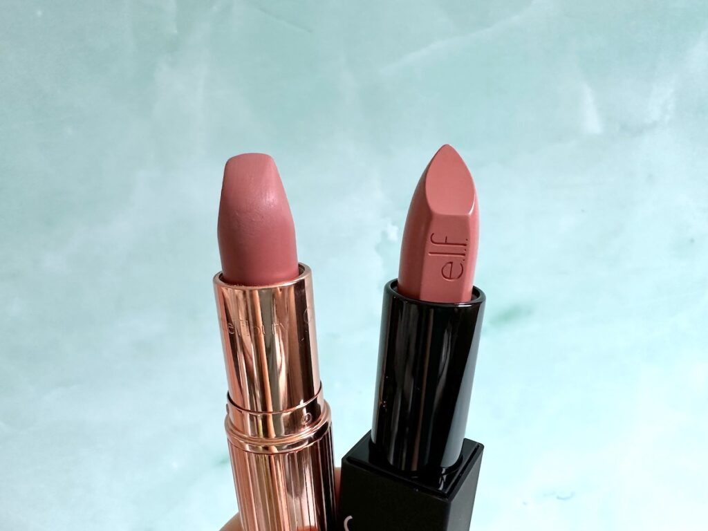 Charlotte Tilbury Pillow Talk lipstick and e.l.f O Face Satin Lipstick in Dirty Talk, handheld.