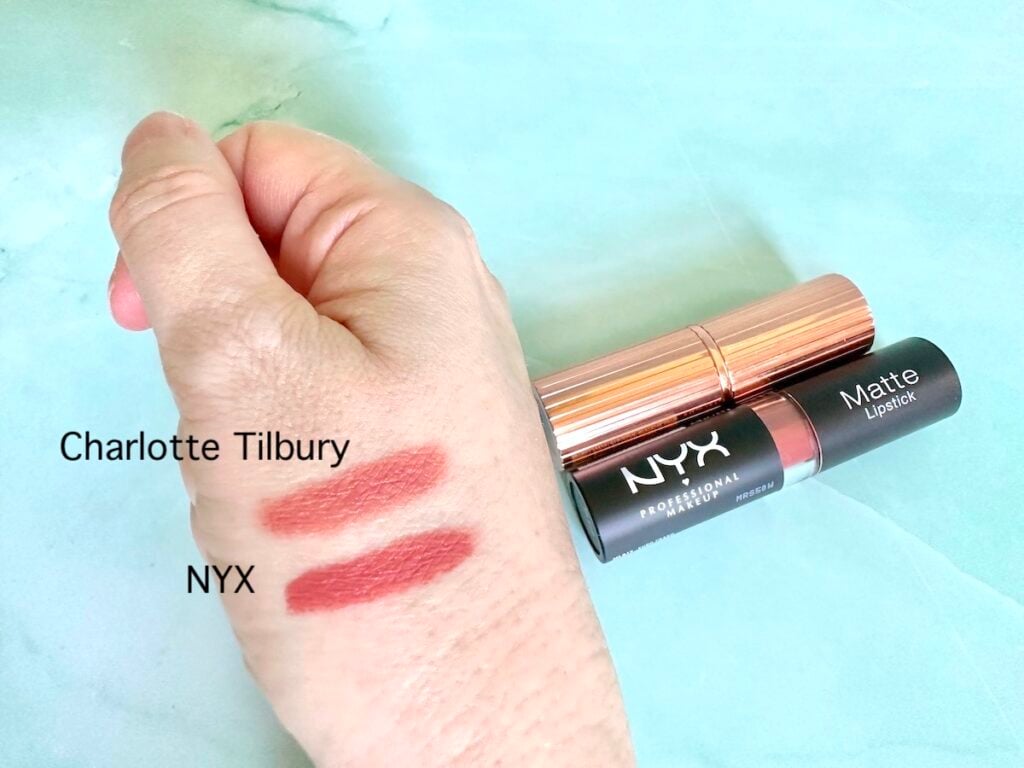 Charlotte Tilbury Pillow Talk Lipstick and NYX Matte Lipstick in Euro Trash flatlay next to samples on hand.