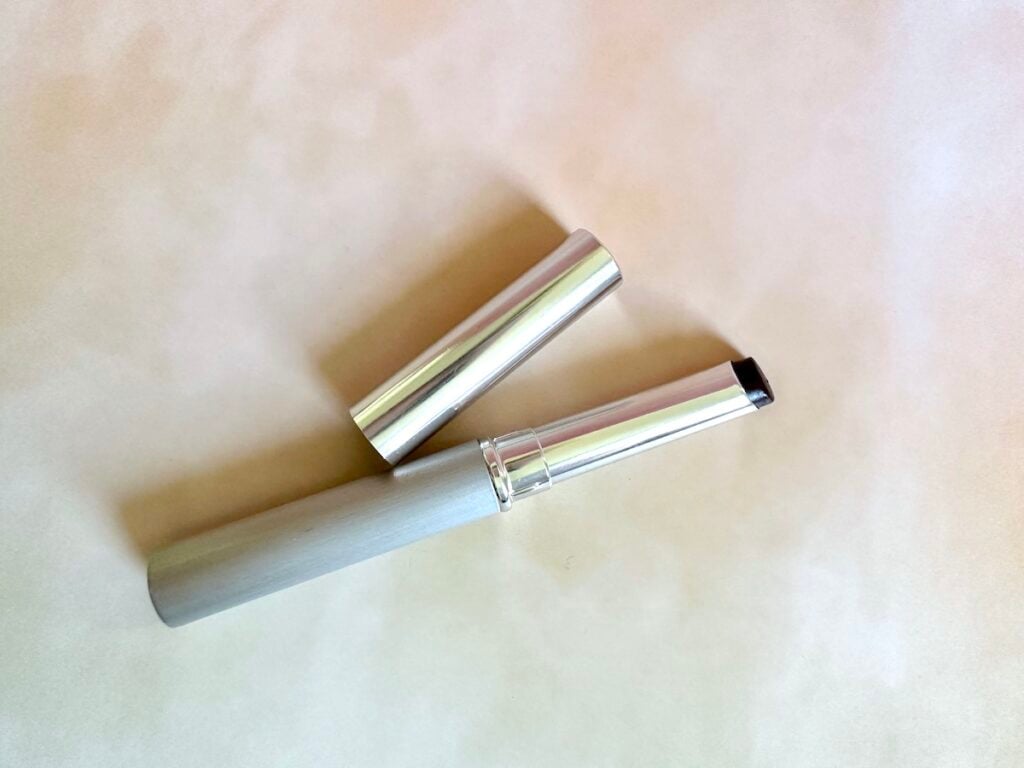 Clinique Almost Lipstick in Black Honey, flatlay of open lipstick tube.