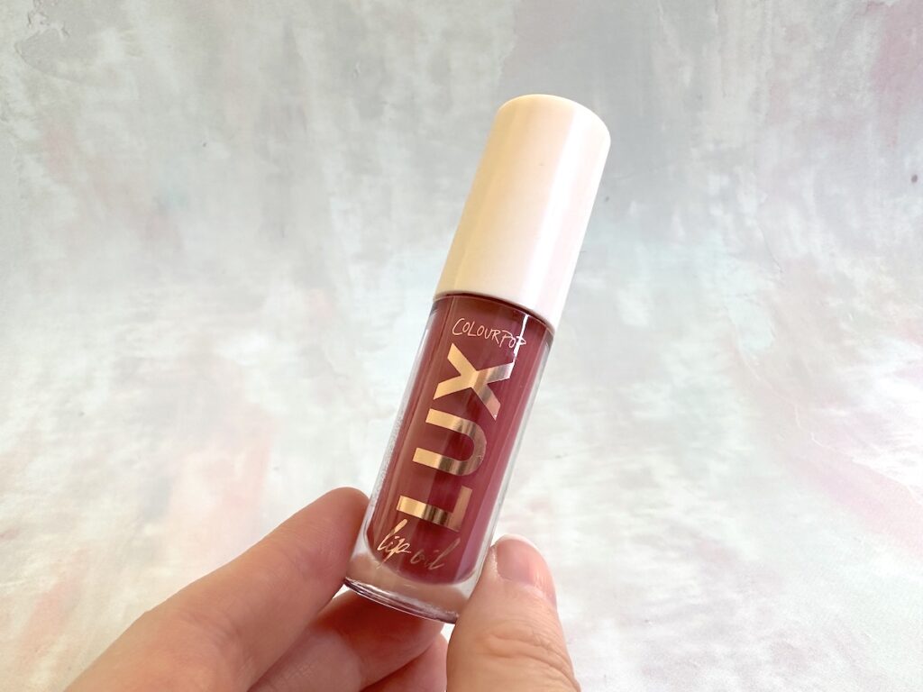 ColourPop Lux Lip Oil in the shade Bengal, handheld..